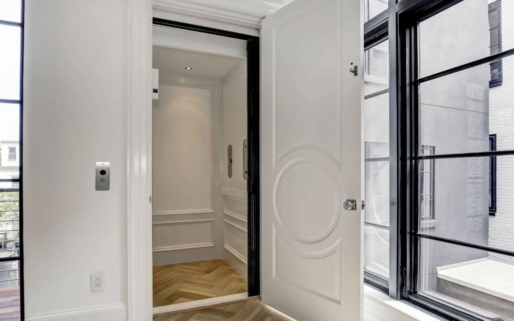Symmetry Home Elevator In A Bright White Finish And Stainless Steel Fixtures Scaled 1